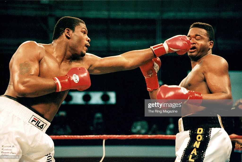riddick-bowe-connects-with-a-left-jab-to-larry-donald-during-the-at-picture-id157078974